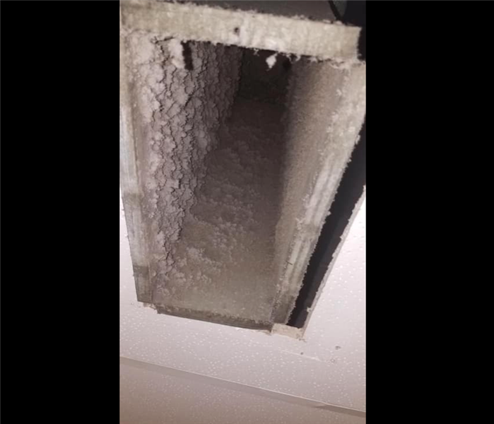 Uncleaned HVAC duct with dust coating the sides