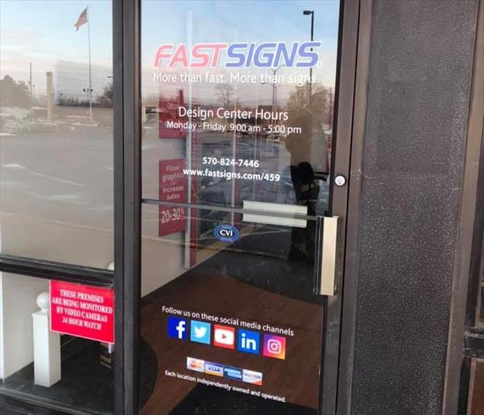 Business door front entrance with text of "FAST SIGNS" on it