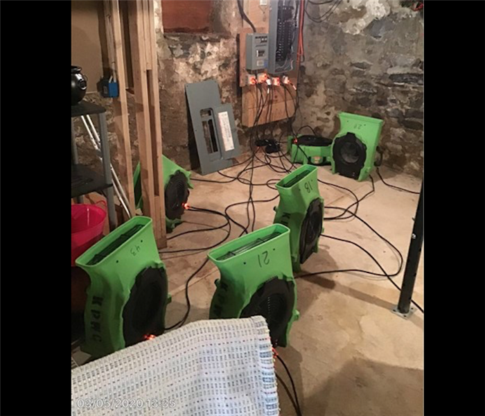 SERVPRO green equipment in concrete basement