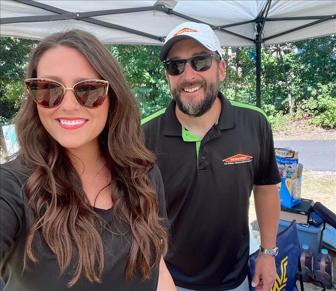 Sales Reps under SERVPRO tent at community event 
