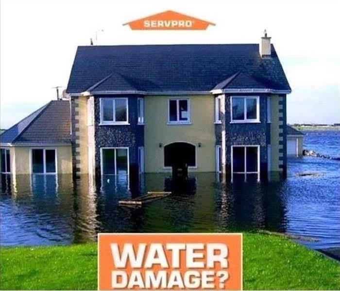 Home surrounded by water with SERVPRO logo and "water damage" text 